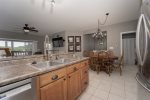 UPPER LEVEL KITCHEN WITH DINING TABLE FOR 6 & BREAKFAST BAR SEATING FOR 2 IN FRONT OF THE SINK